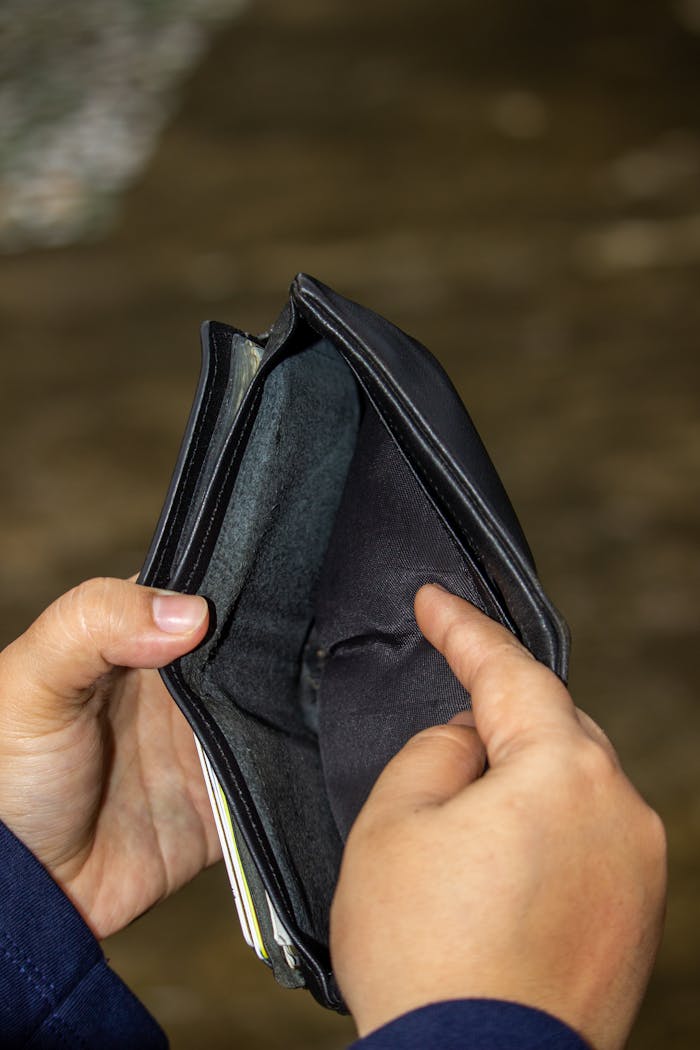 Person Holding a Black Wallet